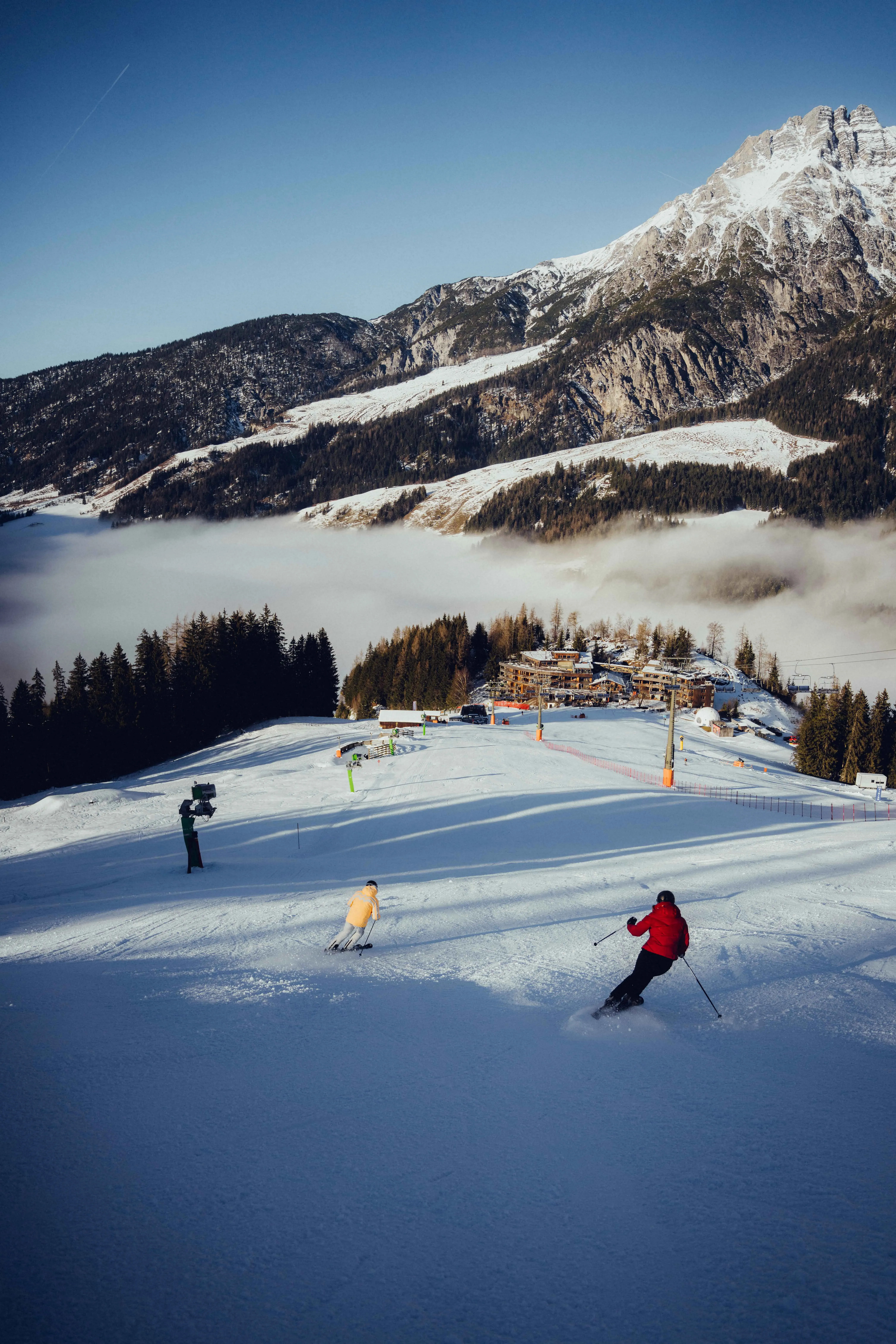 Hotel on the ski slope with skiers